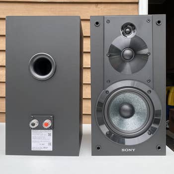 Reviewer image of front and back of black speakers 
