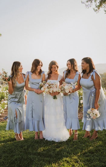 a group of bridesmaids in the blue dress