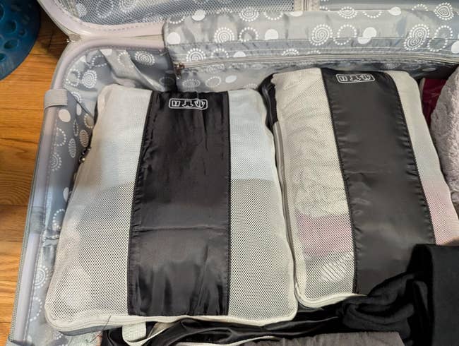 Packing cubes neatly organized successful  an unfastened  suitcase, demonstrating businesslike  question   organization
