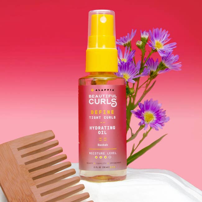 the bottle of hydrating oil against a pink background