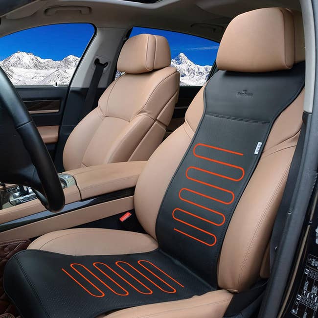 The black heated cushion draped over a front car seat 