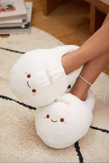 a pair of feet wearing dumpling slippers