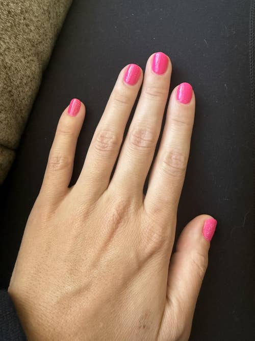 Hand with stylishly manicured nails in a glossy finish