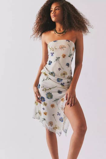 Model poses in a floral strapless dress with asymmetrical hemline for shopping promotion