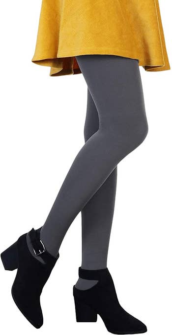 model in opaque gray fleece lined tights and mini skirt and ankle boots