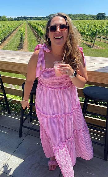 reviewer wearing the dress in pink checkered