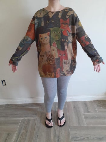another reviewer wearing the same cat-covered sweater