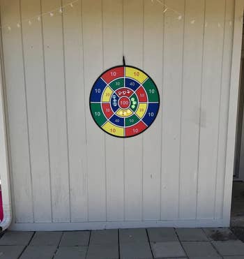 reviewer image of the dart board hanging from an outdoor wall