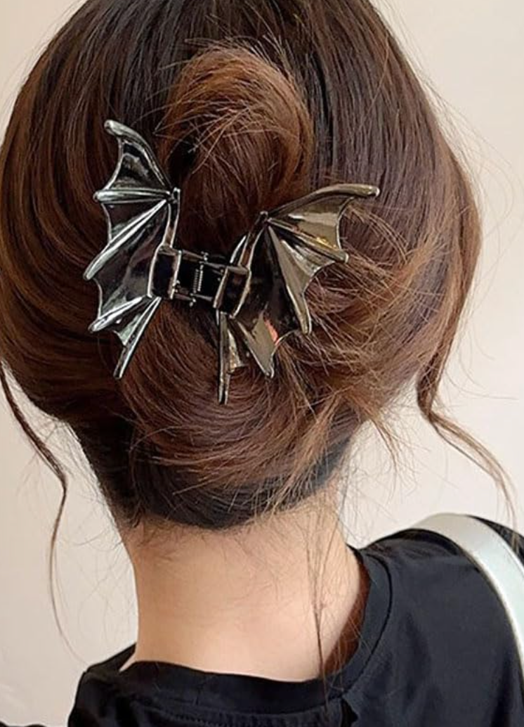A person's hairsbreadth  is styled successful  a bun, secured with a bat wing-shaped hairsbreadth  clip. The hairstyle is simply a sleek, modern   take, cleanable   for unsocial   accessorizing