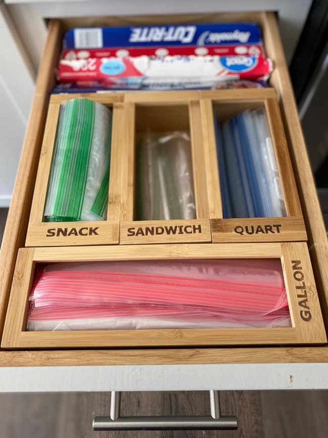 a reviewer shows the four boxes in their kitchen drawer