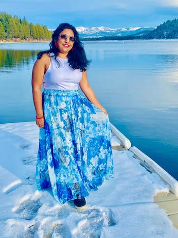 Person successful  a achromatic  sleeveless apical  and floral maxi skirt 