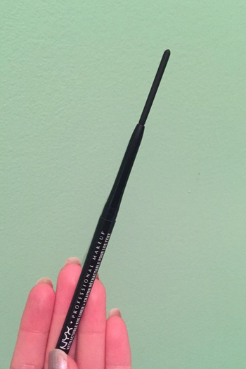 reviewer holding up the eyeliner pencil
