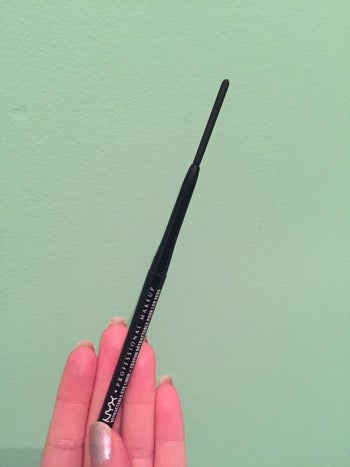 reviewer holding up the eyeliner pencil