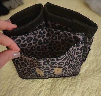 top down view of the leopard print cupholder showing the two cupholders and the stretchy sleeve that attaches to the suitcase handle
