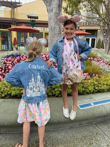two children wearing denim jackets at Disney