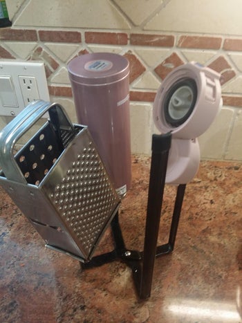 rack drying water bottle and cheese grater