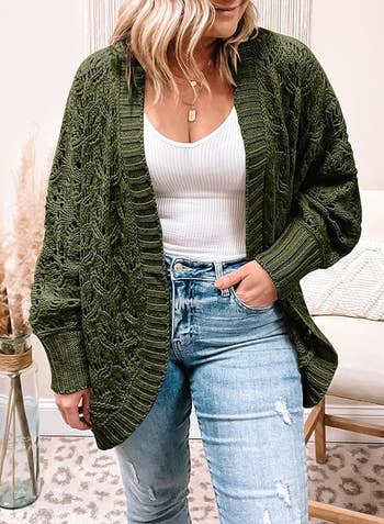 model wearing dark green open front crochet cardigan