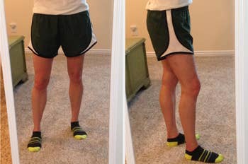 reviewer wearing the loose running shorts in dark green, showing a front and side view