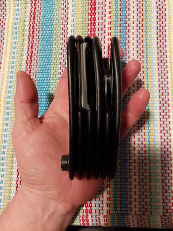 A manus  holding the tool, showing its compact size