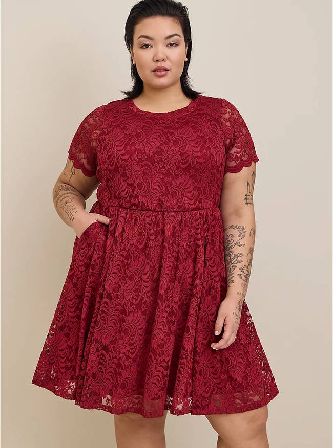 model in red short sleeve knee length dress