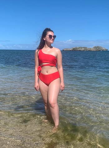 another reviewer at the beach wearing the red bikini