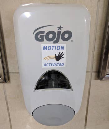 Wall-mounted hand sanitizer dispenser with motion aci