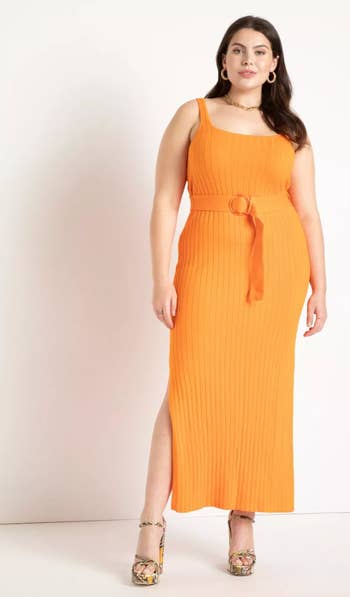 front view of model in orange knit midi dress