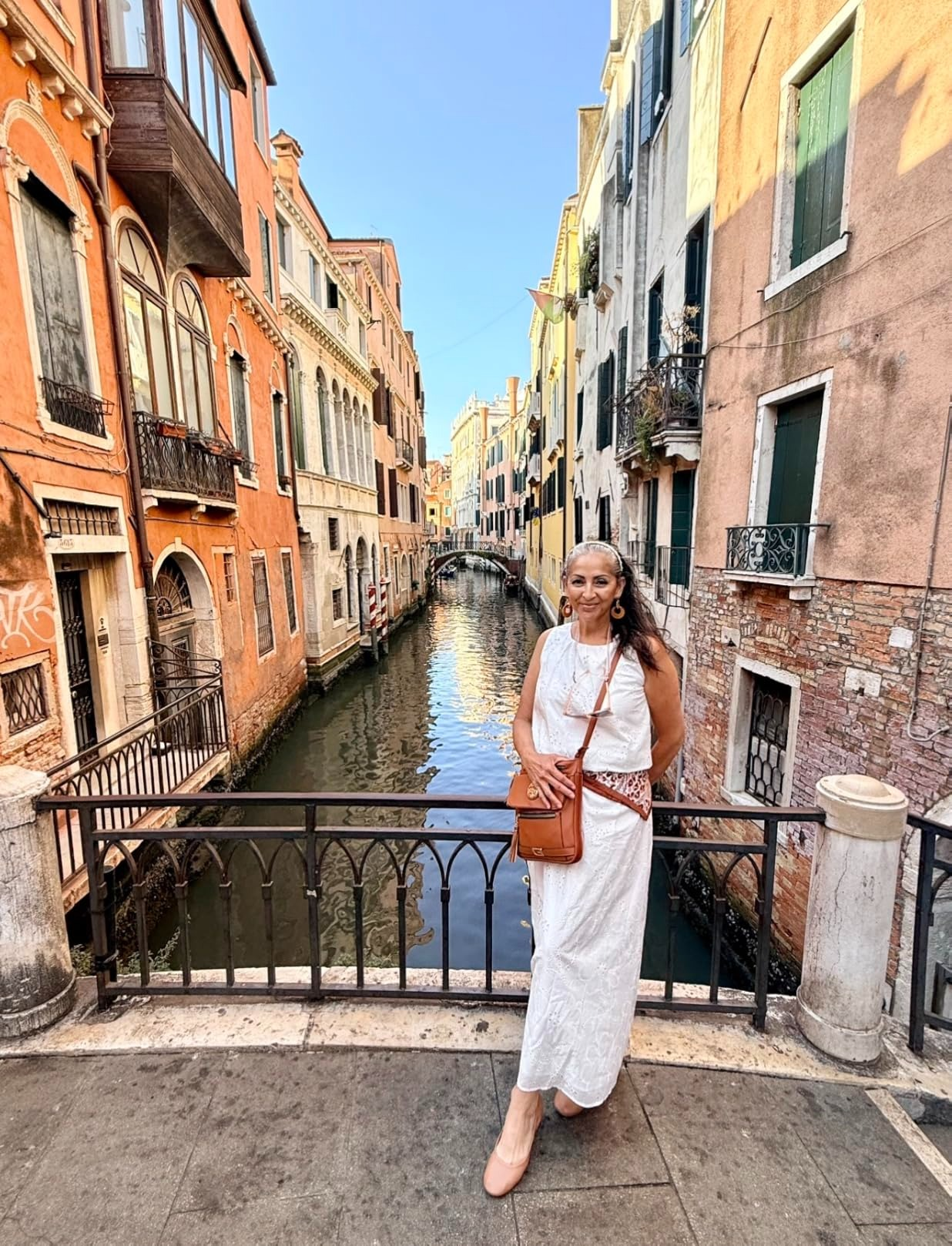 Person successful  a achromatic  summertime  formal  posing by a canal successful  a historical  metropolis  setting