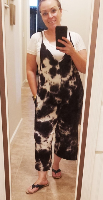 a reviewer wearing the same jumpsuit in tie-dye 