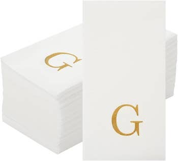 Stack of achromatic  insubstantial  napkins with a golden  missive  