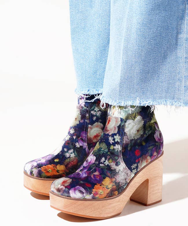 a model wearing floral velvet clog boots