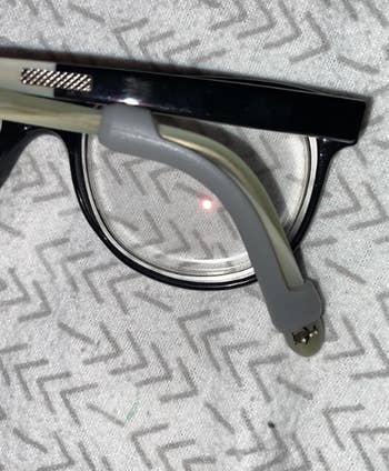 Close up of glasses showing the eyeglass sleeve on them