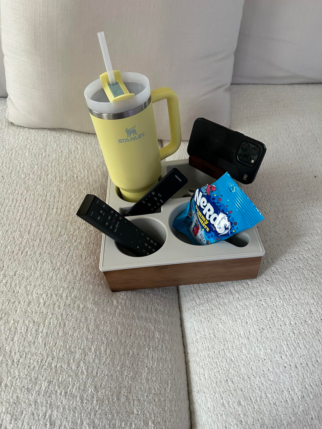 Organizing tray holds a Stanley tumbler, phone, 2  remotes, and a candy bag, perfect  for sofa-side convenience
