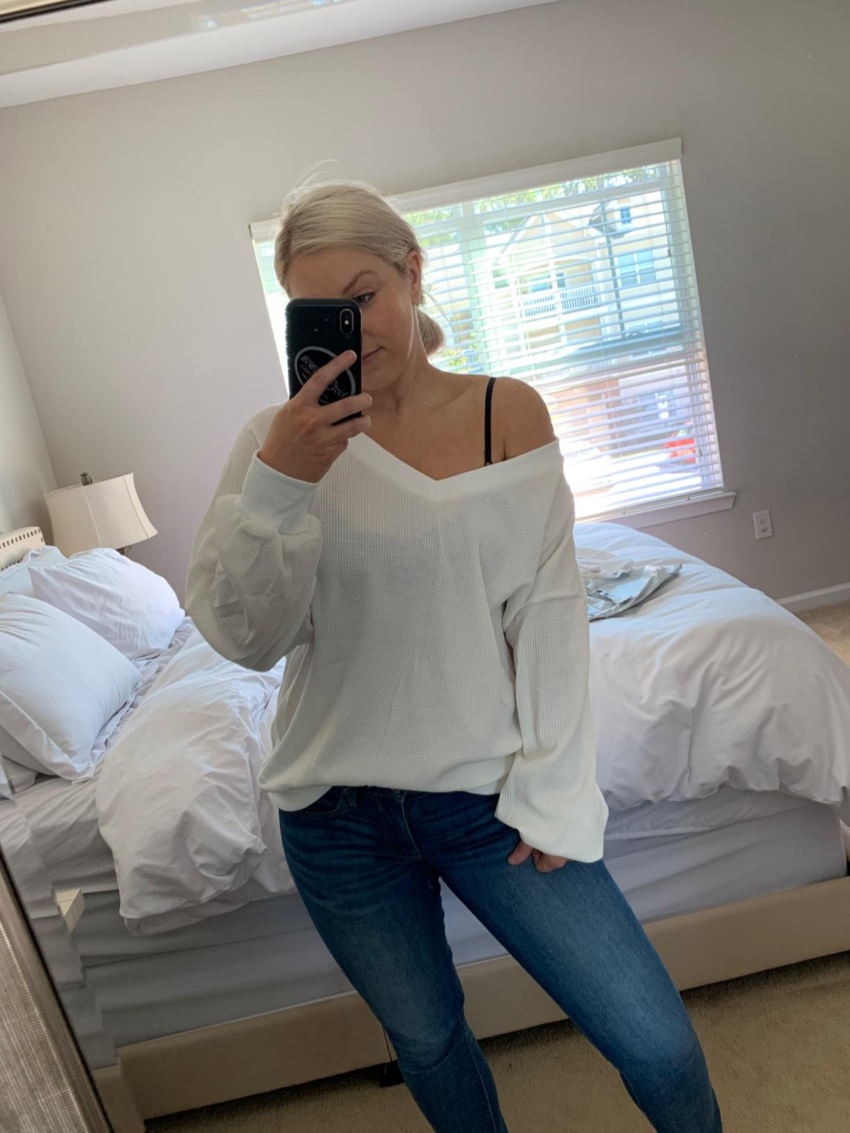 reviewer wearing the white v-neck sweater off the shoulder