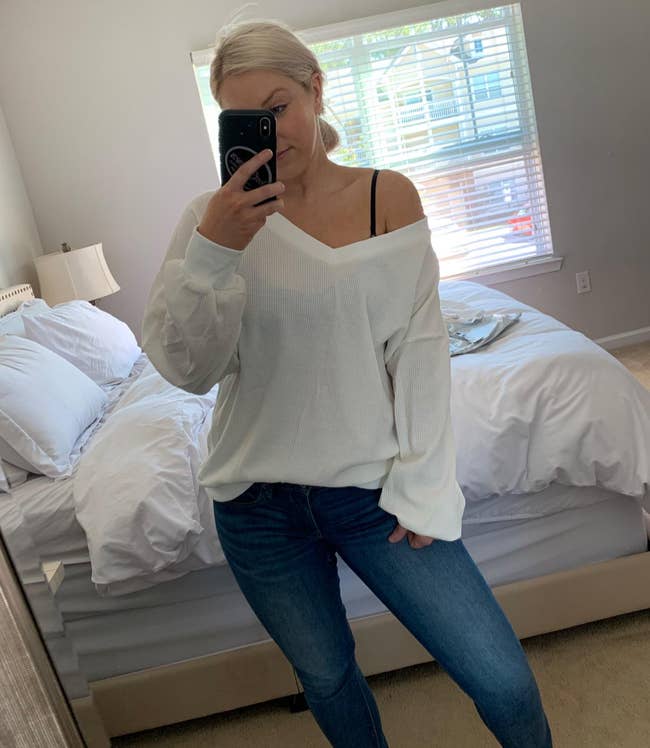 reviewer wearing the white v-neck sweater off the shoulder