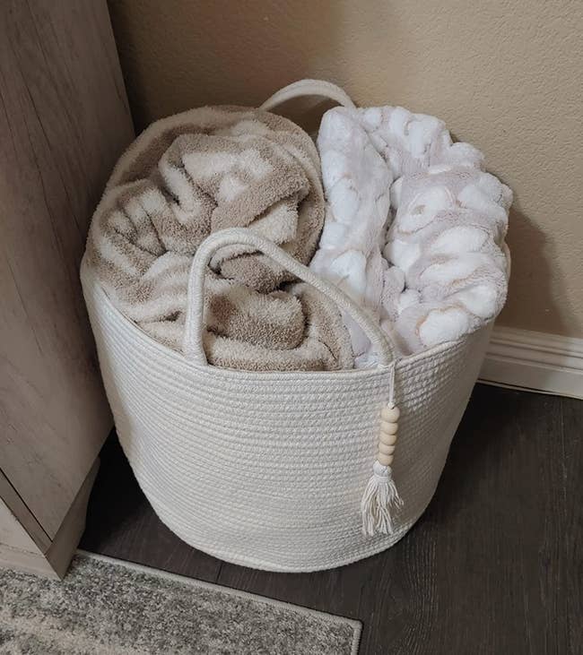 Reviewer photo of the storage basket with blankets in it