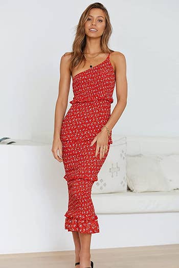 model in the one-shoulder red floral dress