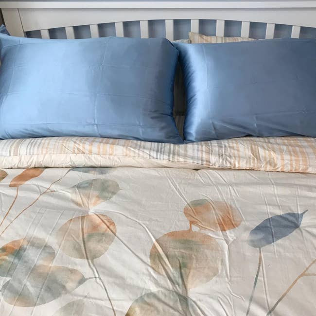blue silk pillowcases on a bed