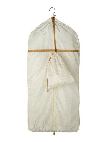 A white garment bag on a hanger with an attached drawstring bag 