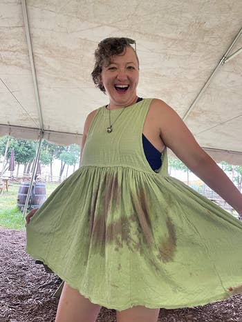 reviewer wearing light green dress with red wine stains