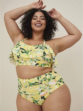 front view of model wearing lemon-printed ruffle swim top and bikini bottoms