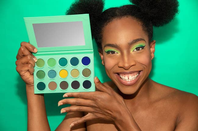 shop owner, junior mintt holding the mint colored eyeshadow palette