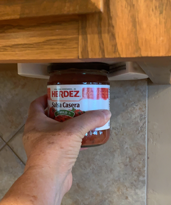 reviewer using the opener to open a jar of salsa