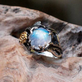 The ring has a mystical band around the blue moonstone that looks like dragons