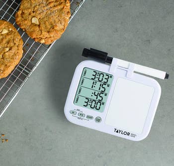 the four-way timer with four timers set next to a rack of cookies