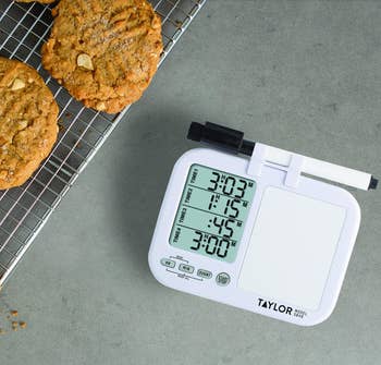 the four-way timer with four timers set next to a rack of cookies