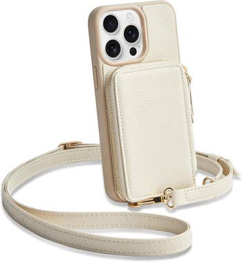 Phone case with attached wristlet and gold accents, featuring a zippered pouch for carrying small items