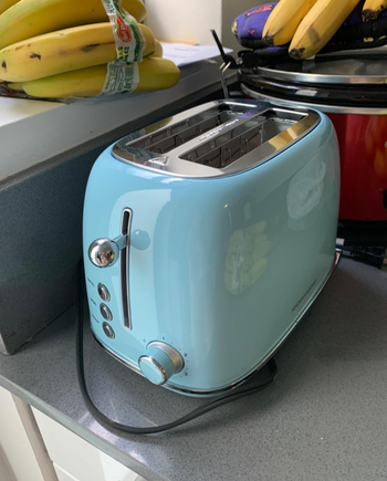 A retro looking light blue toaster 
