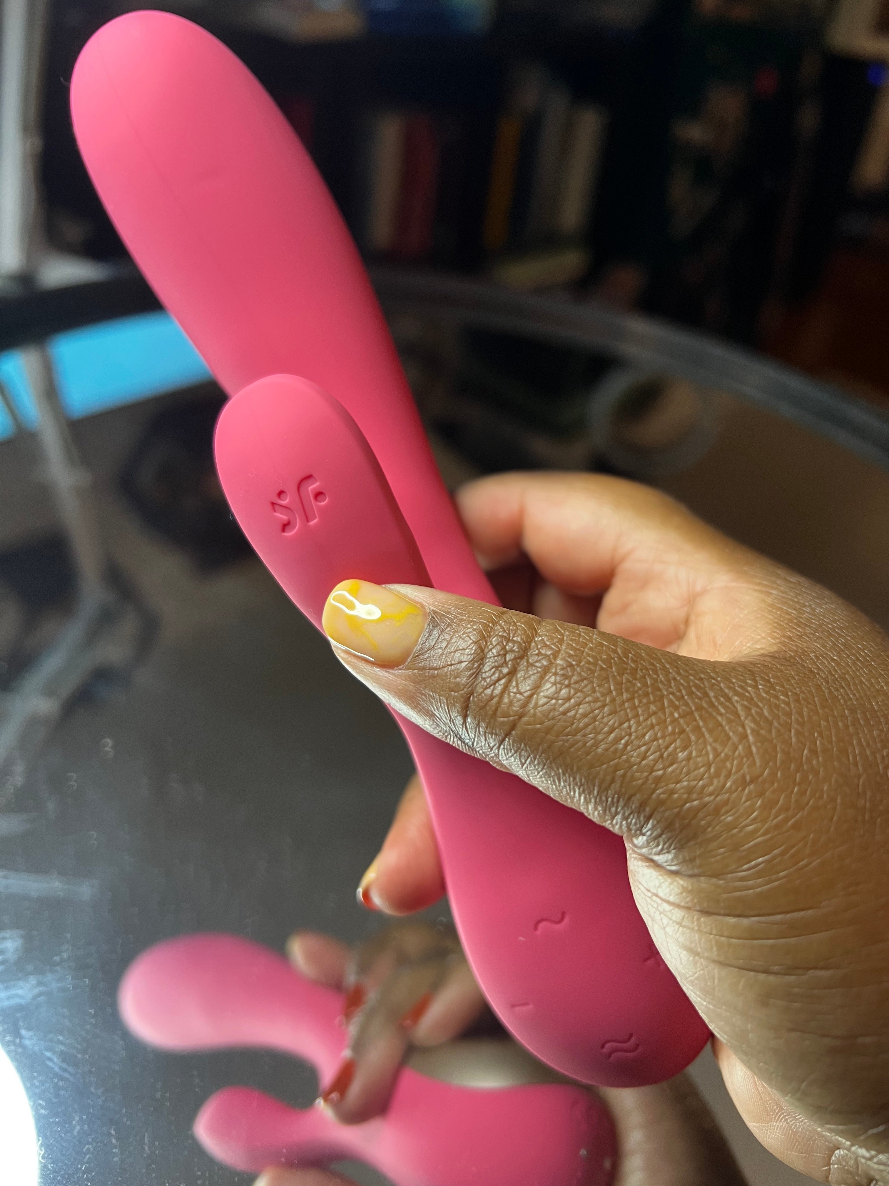 Hand holding red rabbit vibrator