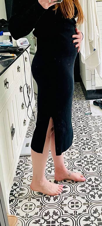 reviewer wearing the black skirt showing the side slit